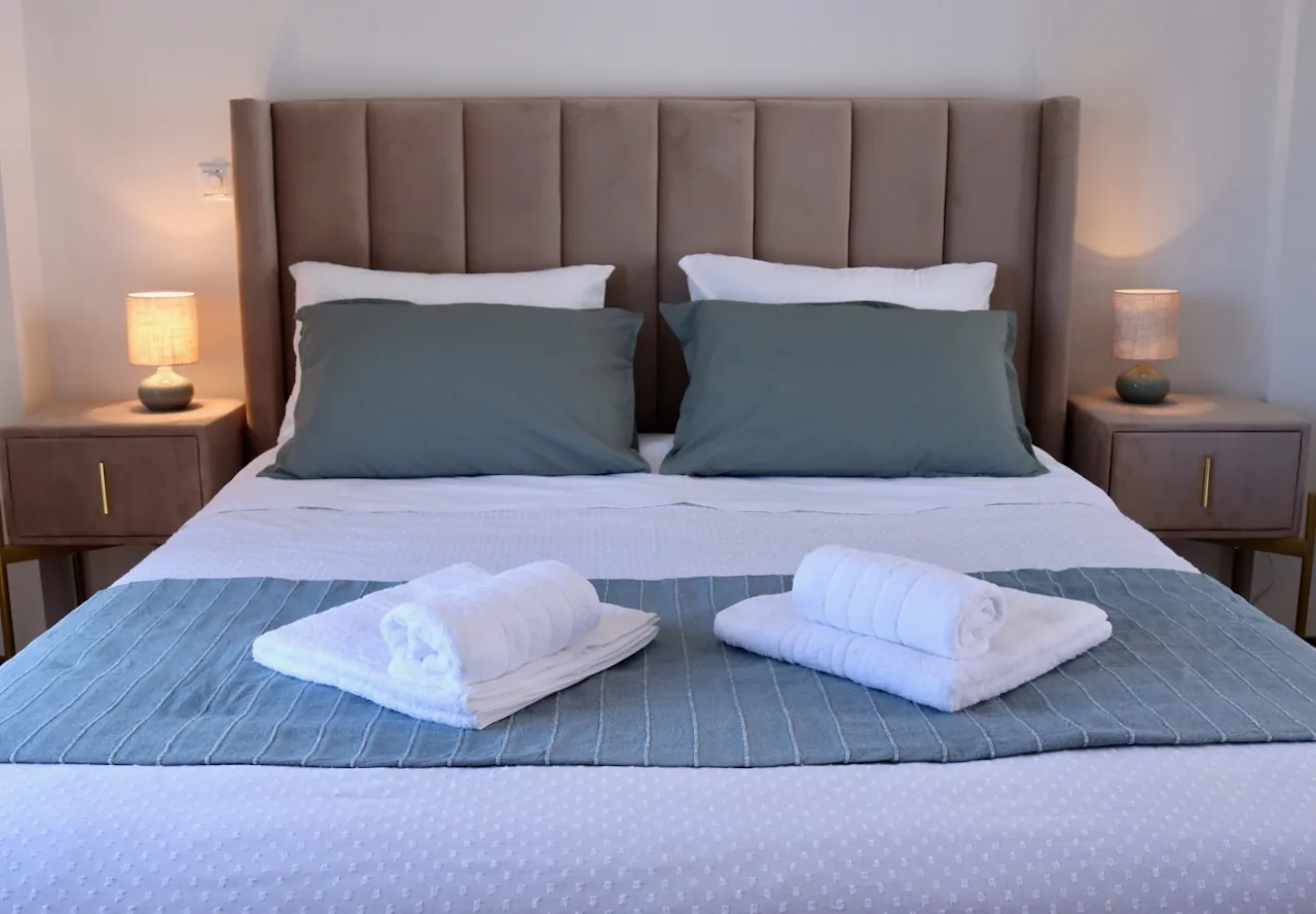Styled bedside table and comfortable bed