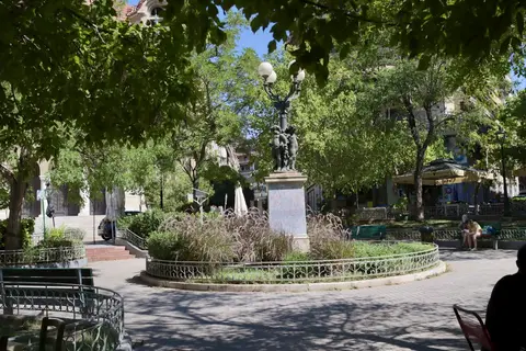 Agios Georgios Square in Kypseli, Athens, with the church, trees and outdoor café tables.