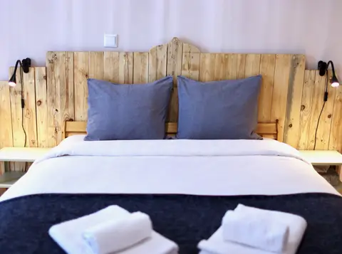 Separate bedroom with double bed and blue pillows